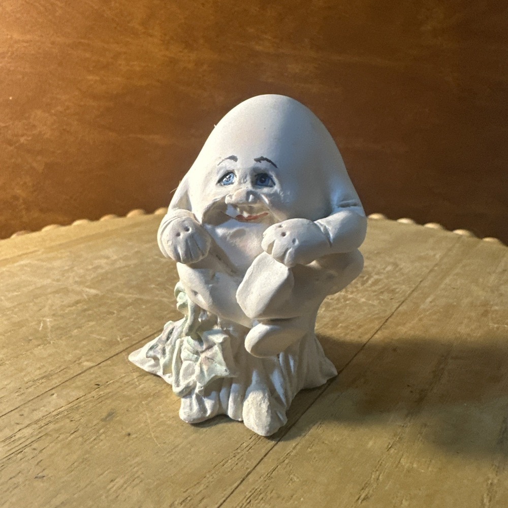Vintage 1993 Allyson Nagel Signed Humpty Dumpty Egg Figure sitting on a stump.